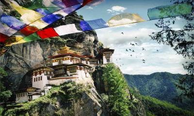 Bhutan cuts daily tourist fee by half