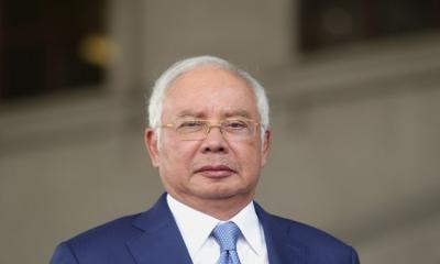 Malaysia halves jail term of ex-PM Najib