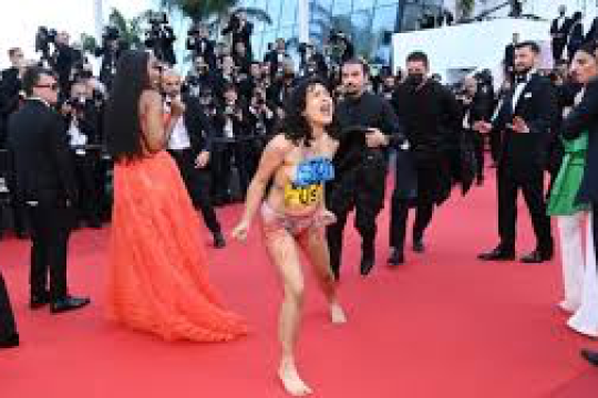 Woman takes off dress on Cannes red carpet to protest Ukraine rapes