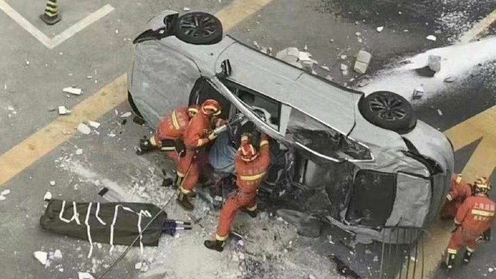 Two killed as electric car falls from China office