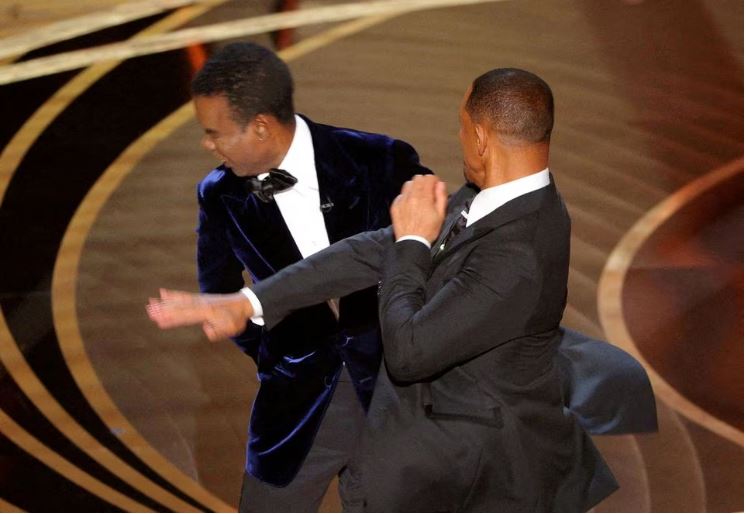 Chris Rock unleashes on Will Smith and wife Jada a year after Oscars slap